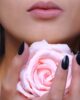 woman holding pink rose flower