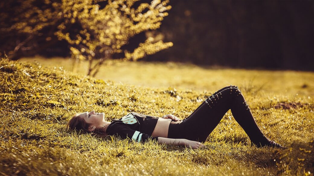 girl lying on the grass wearing legging